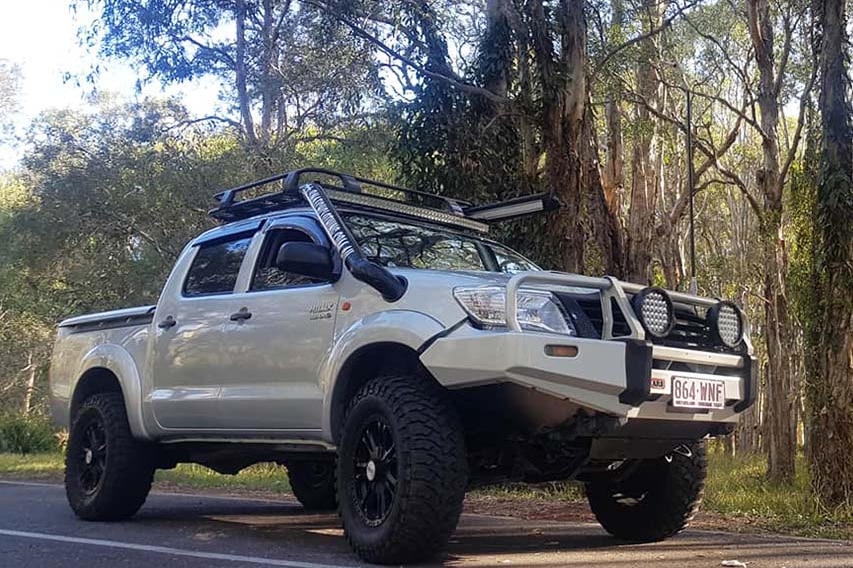 The silver-coloured Toyota Hilux dual cab owned by Bobby Cook, parked on a road beside bushland.