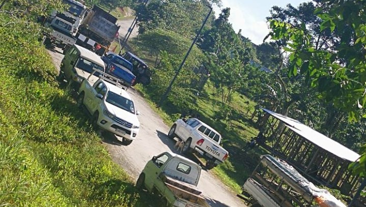 Trucks block the road and entrance to the refugees' accommodation on Manus Island