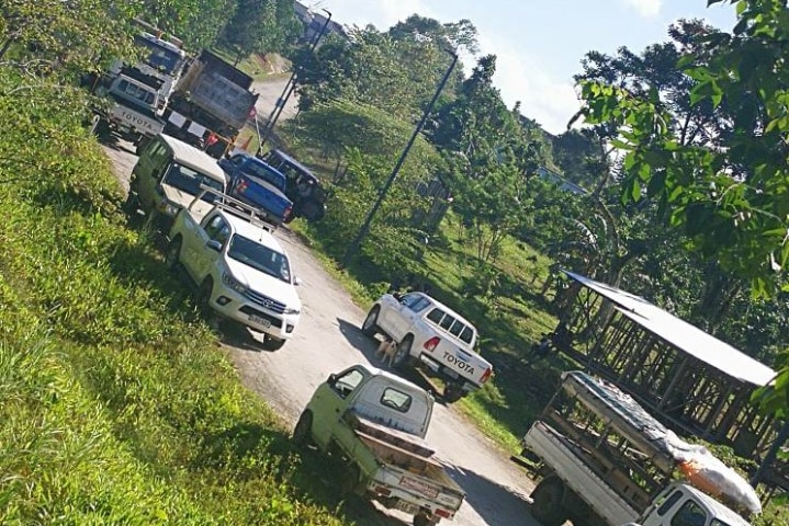 Trucks block the road and entrance to the refugees' accommodation on Manus Island