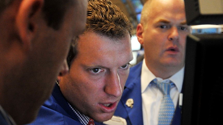 Stock specialists work on the floor of the New York Stock Exchange just before the closing bell August 5, 2011.