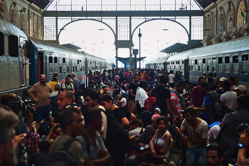 Migrants and refugees crowd railway platforms in Budapest