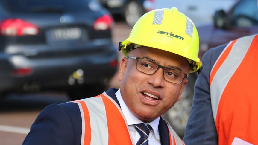 Sanjeev Gupta, in a hard hat, looks slightly to his right.