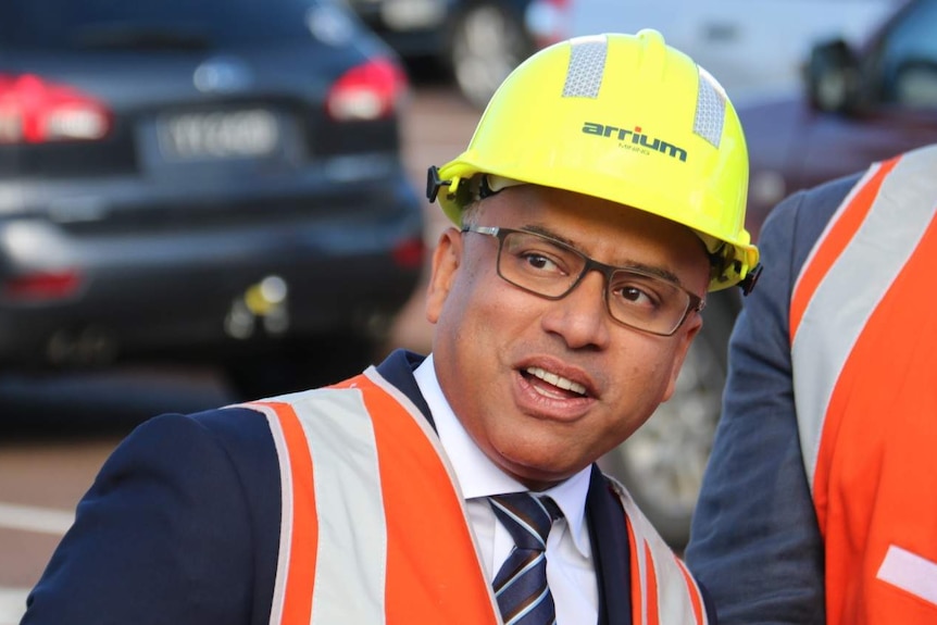 Sanjeev Gupta, in a hard hat, looks slightly to his right.