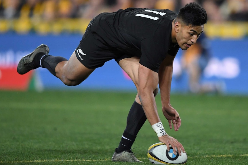 Rieko Ioane grounds the ball with one hand in scoring a try for the All Blacks.