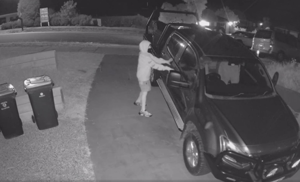 a screenshot of vision of a young person seeing if a car door is unlocked, car is in driveway 