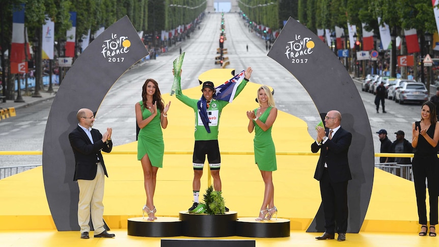 Michael Matthews celebrates on the Tour de France podium with green jersey