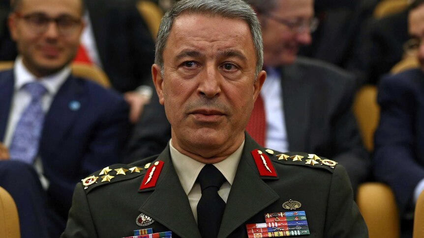 General Hulusi Akar sits in his army uniform.