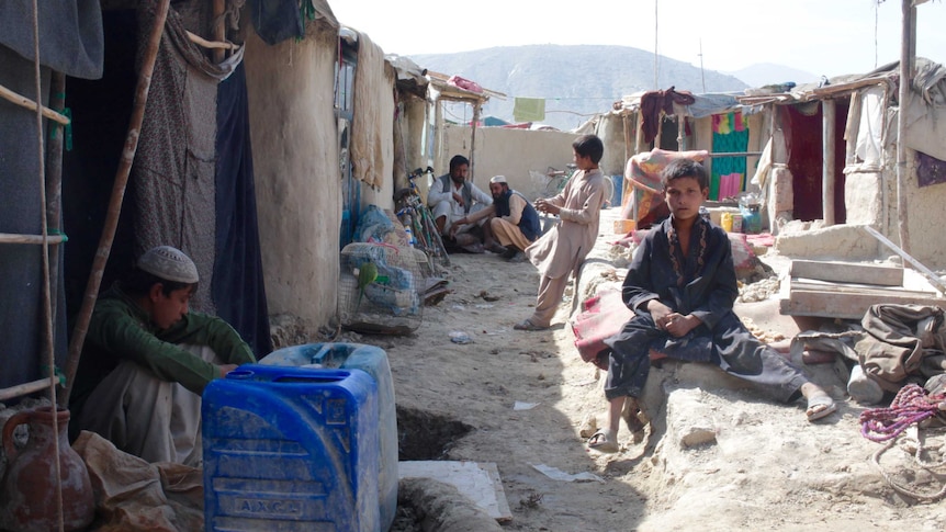 People surrounded by the squalor of Kabul's slums