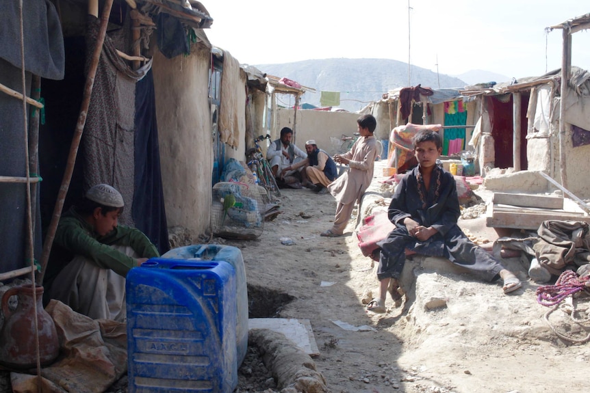 People surrounded by the squalor of Kabul's slums