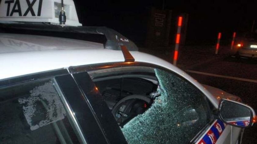 A Perth taxi driver escapes serious injury when a bottle was thrown at his cab.