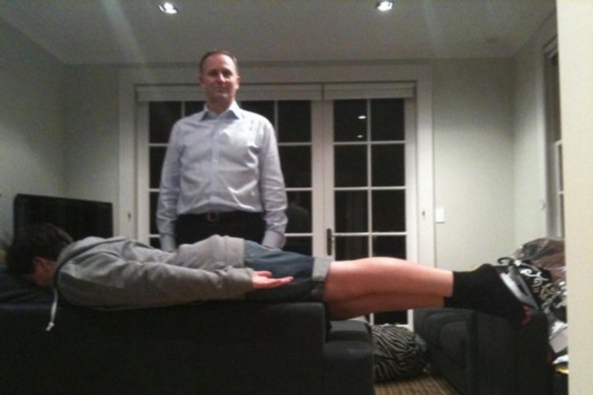 New Zealand prime minister John Key watches his son Max Key planking.
