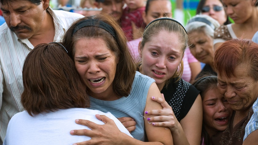 Relatives of victims of a child care fire in Mexico cry
