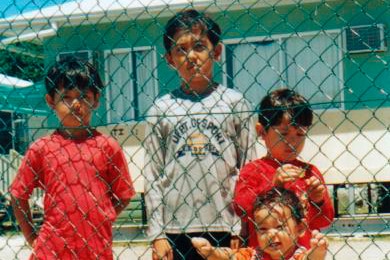 Children behind a fence in Nauru (AAP: Rural Australians for Refugees)