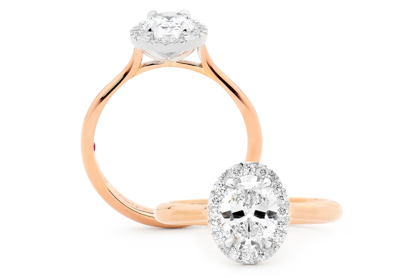 Two images, a side view and a top down view, of the same gold ring with a white oval diamond