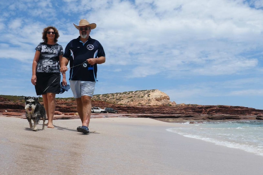 Bren and Ken MacDibble walking along the beach in Kalbarri, Western Australia