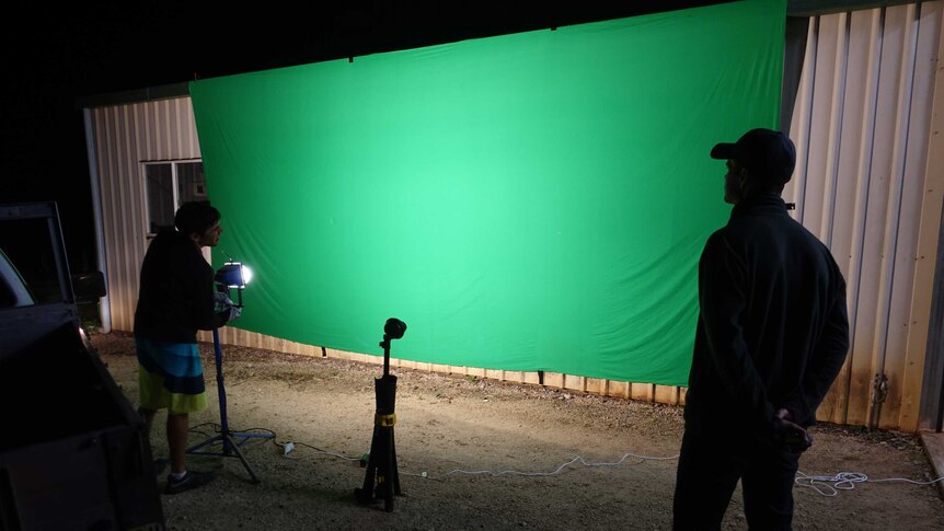 Cameraman Nick De Gabriele and producer Shawn Brack setting up a green-screen for a visual effects shot.