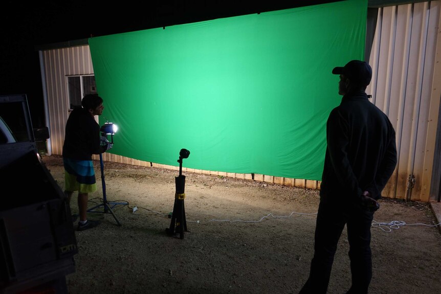 Cameraman Nick De Gabriele and producer Shawn Brack setting up a green-screen for a visual effects shot.