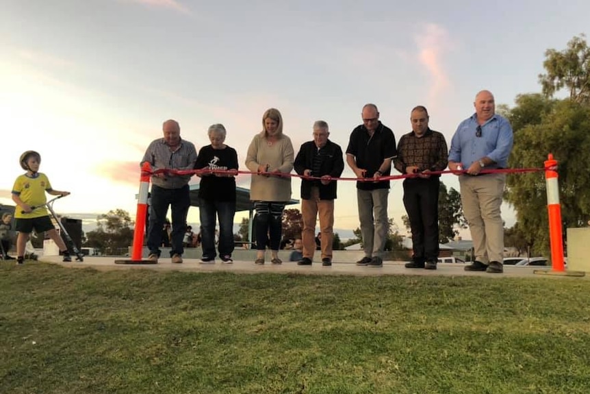 Seven members of the Wentworth community cut a ribbon at the skatepark.
