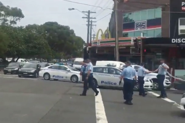 Several police officers pointing.