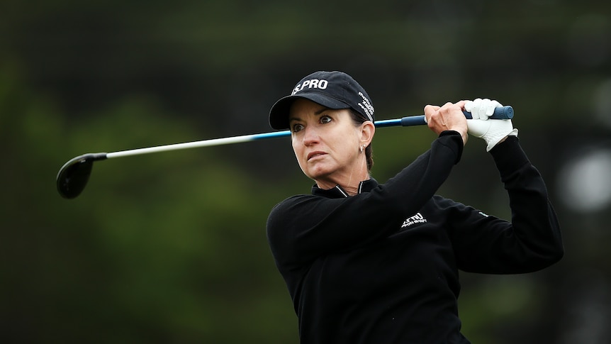 Close-up shot of Karrie Webb teeing off during the Vic Open at 13th Beach Golf Club. She is dressed in black with a black hat