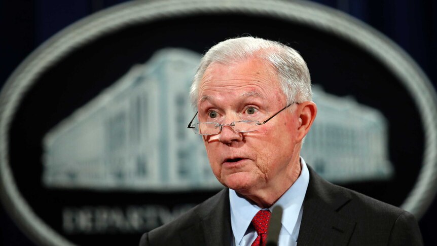 United States Attorney General Jeff Sessions looks over his glasses.