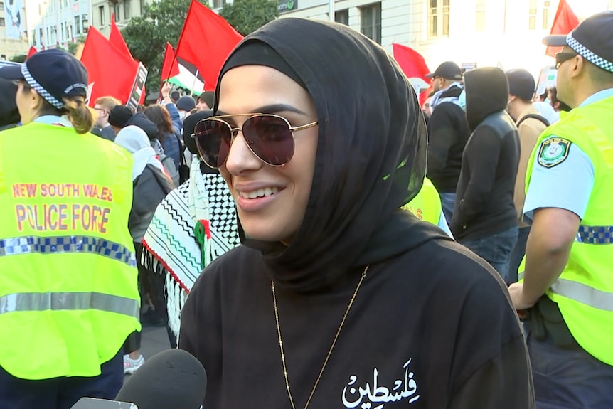 a woman wearing dark glasses with her head covered 