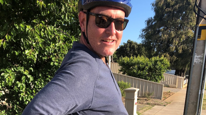 A man in a bike helmet
