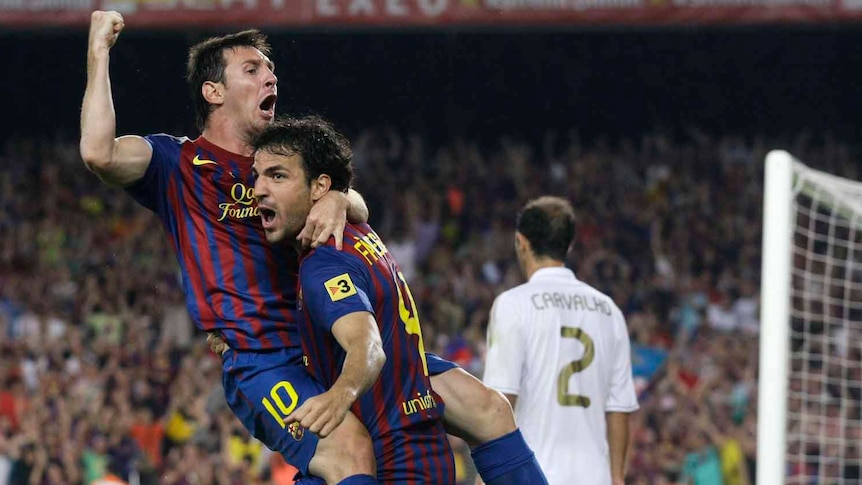 Super Cup glory ... Barcelona's Lionel Messi (L) volleyed home the winner while Cesc Fabregas (R) made his long-awaited debut for the Blaugrana.