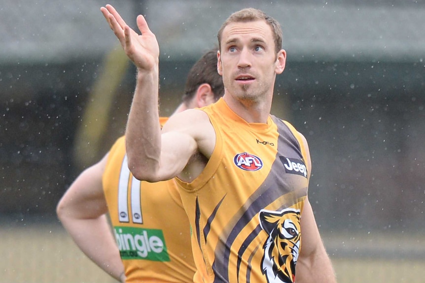 Shane Tuck looks at a ball that he has thrown in the air at training