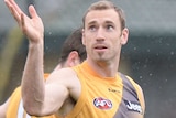 Shane Tuck looks at a ball that he has thrown in the air at training