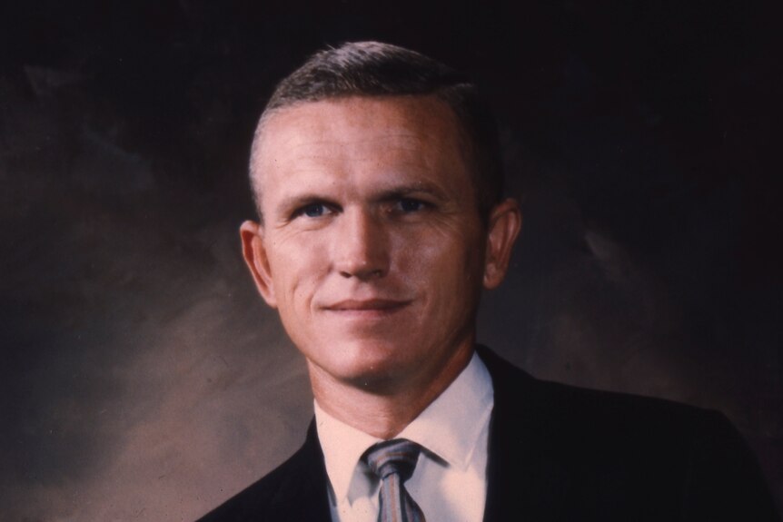 Man poses for portrait in 1960s wearing suit 