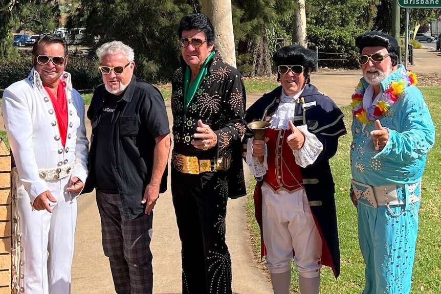Five men dressed up in various Elvis Presley outfits