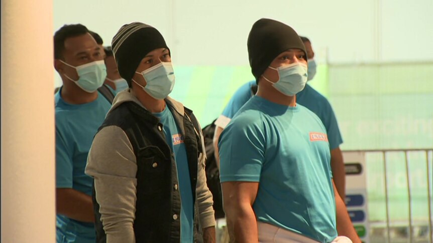A group of men wearing face masks