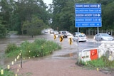 Cars drive through floodwaters