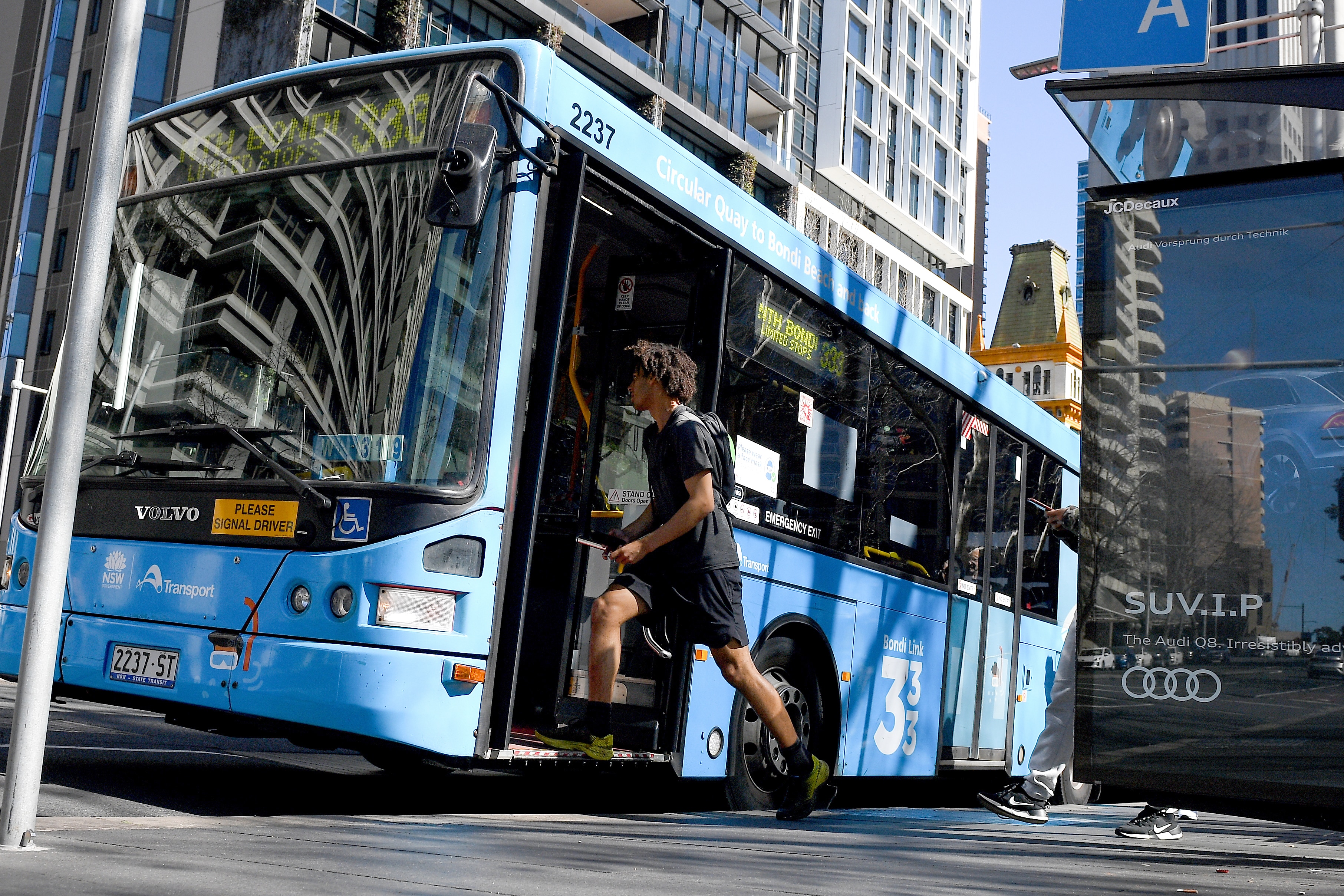a young man about to get on a bus