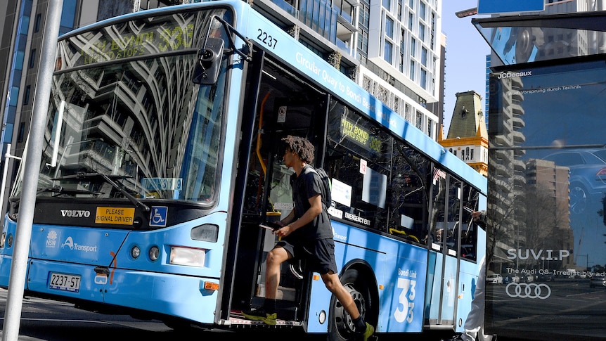 a young man about to get on a bus