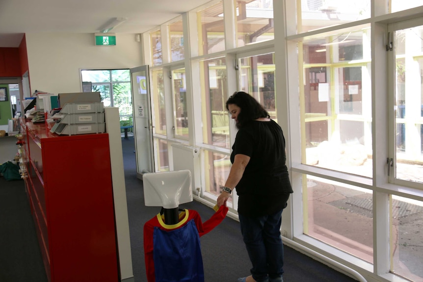 Lizzie Christiansen-Young guides her daughter’s telepresence robot down the hallway at Yarralumla Primary School.
