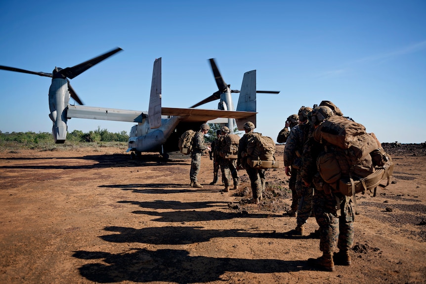 troops walking towards an osprey aircraft
