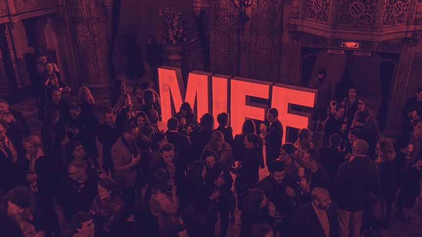 crowd at a party with a big red MIFF sign