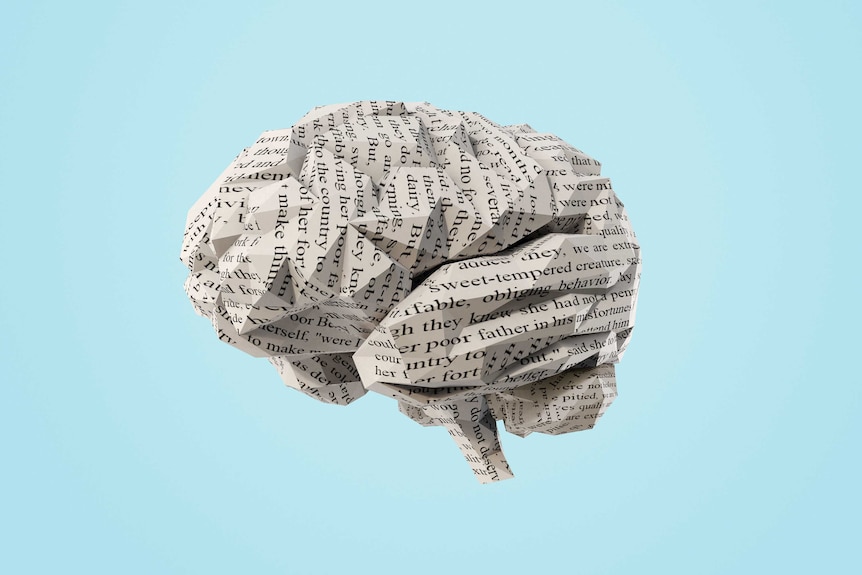 An origami brain made of paper with printed writing on it.