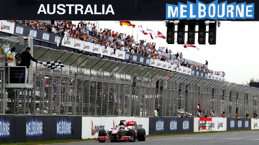 Jenson Button takes the chequered flag to win in Australia for the second straight year.