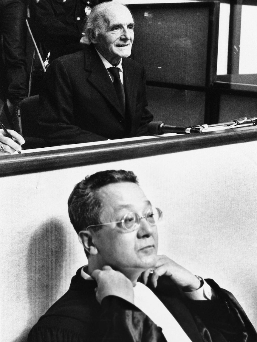 Jacques Verges sits in front of Klaus Barbie in the Lyon Assize court.