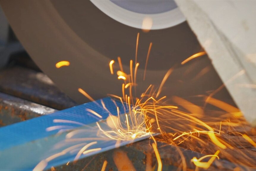 Blade on steel throwing sparks