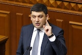 Ukrainian Parliament Speaker Volodymyr Groysman raises a hand while speaking.