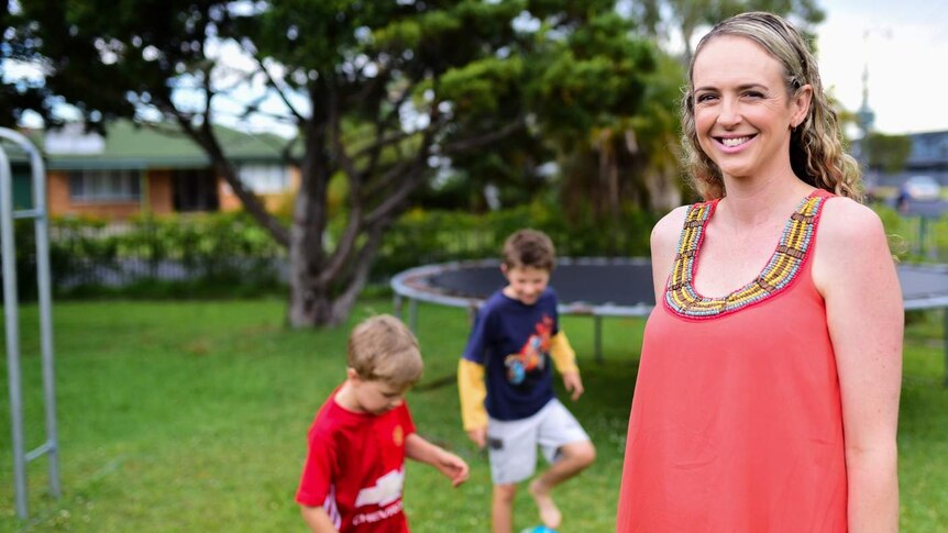 Nicki Jeffrey with her two boys in her yard