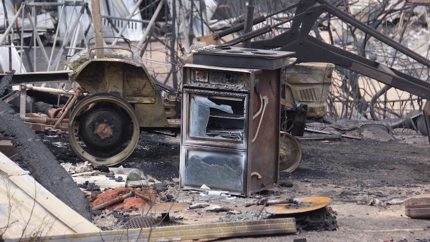 An oven amongst the debris of a home.