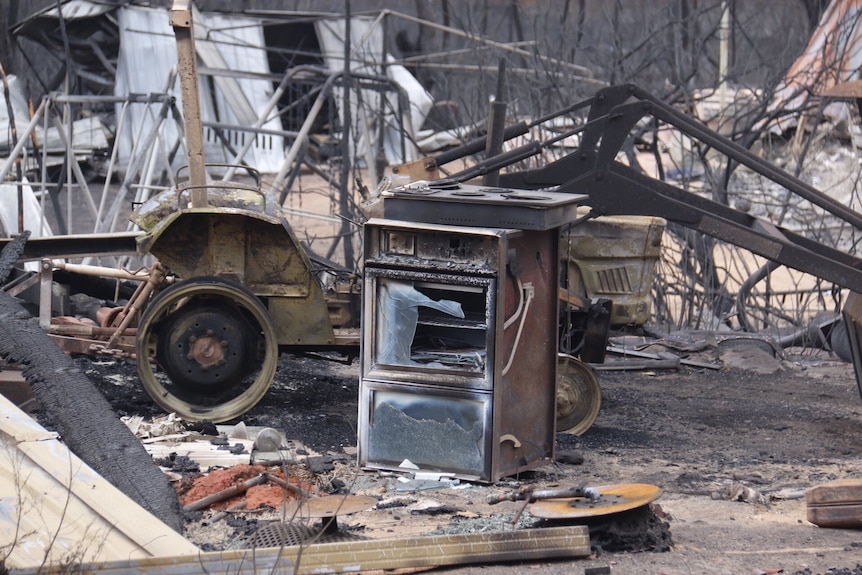 An oven amongst the debris of a home.