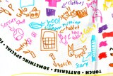A white pillowcase with child's drawing and writing of items to include in an emergency including, small pillow, radio, clothes.