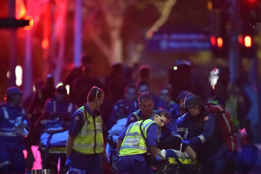 Paramedics with injured hostages at Martin Place