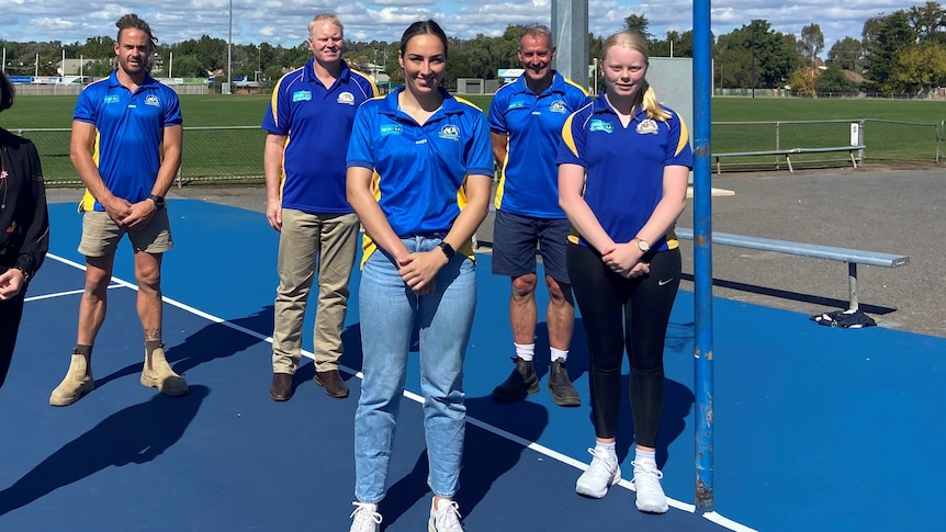 Five members of the Golden Square Football Netball Club standing on a netball court.